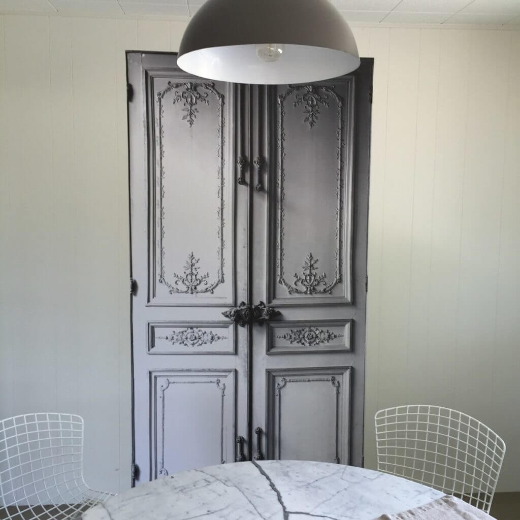 Wallpaper tromp-l'oeil by Maison Martin Margiela ads whimsy to the separate dining room.