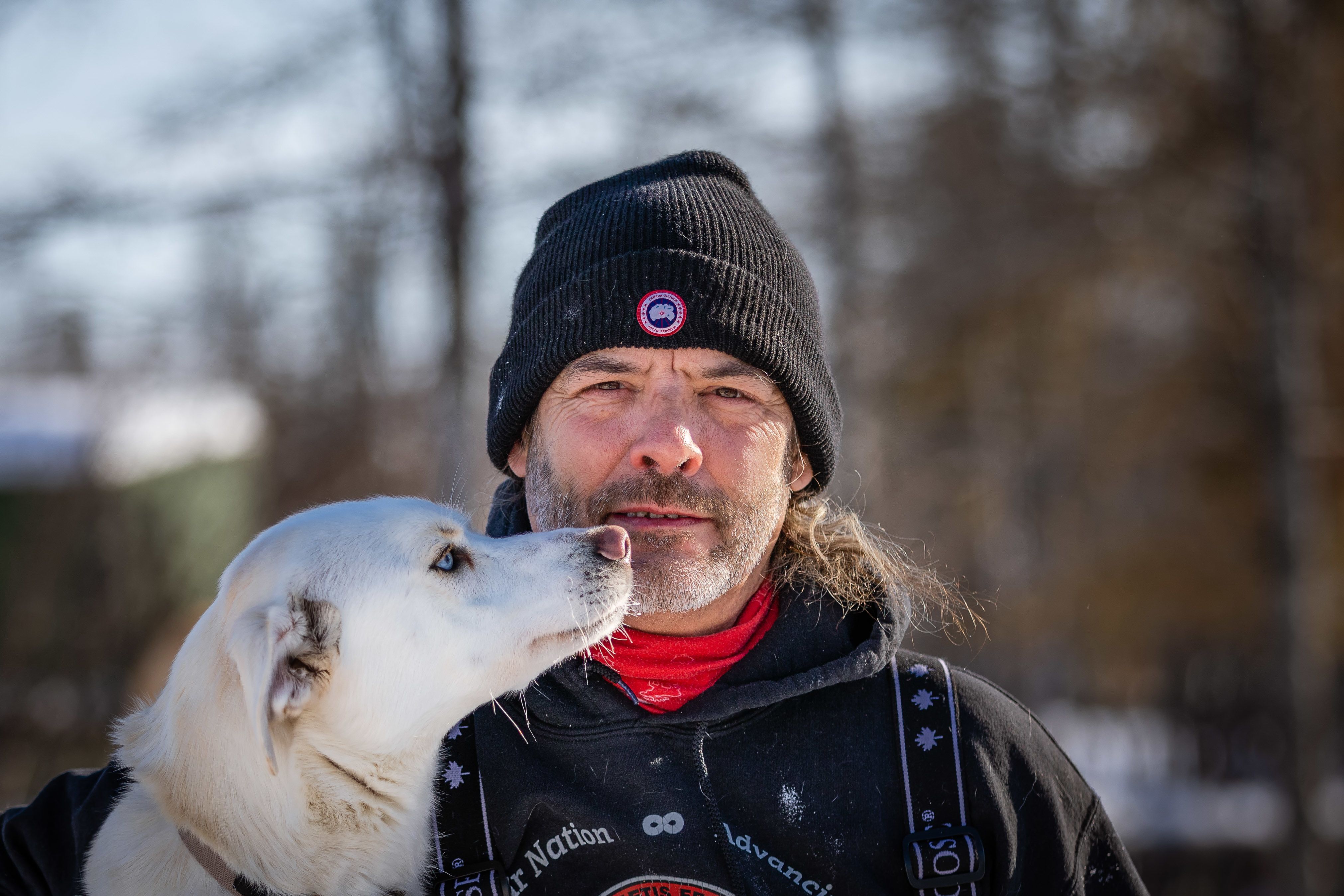 Close up of man with sled dog